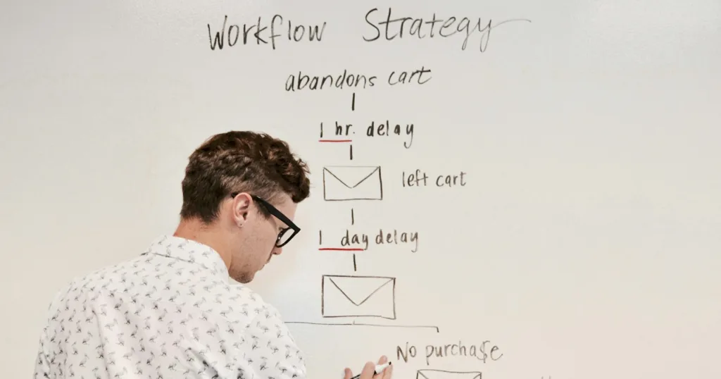 man writing on whiteboard